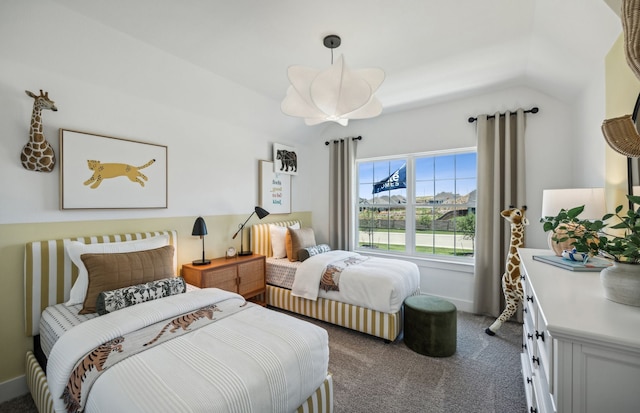 bedroom with vaulted ceiling and dark colored carpet