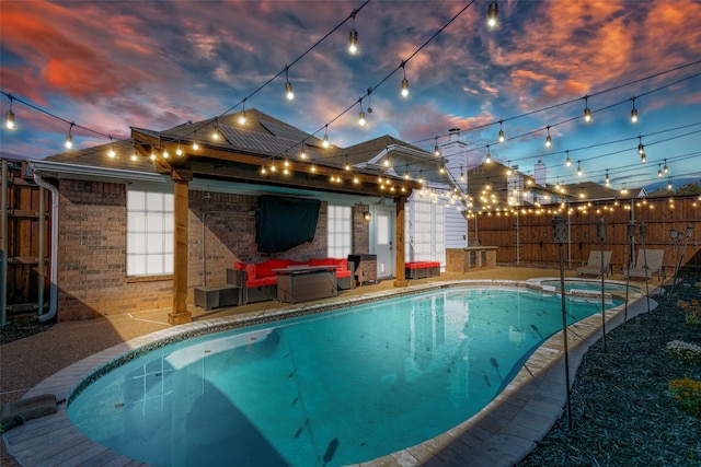 pool at dusk with a patio