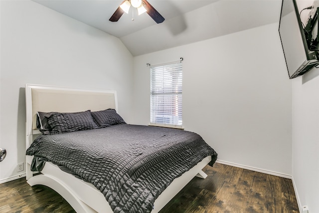 bedroom featuring dark hardwood / wood-style floors, vaulted ceiling, and ceiling fan