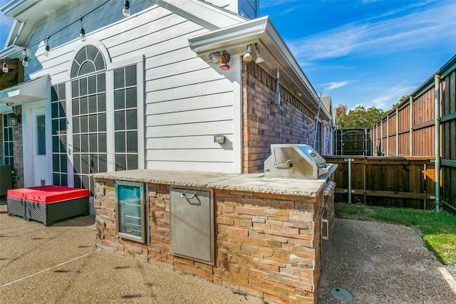 exterior space featuring a patio area and exterior kitchen