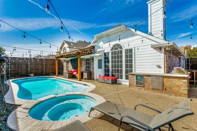 view of swimming pool with an in ground hot tub and a patio