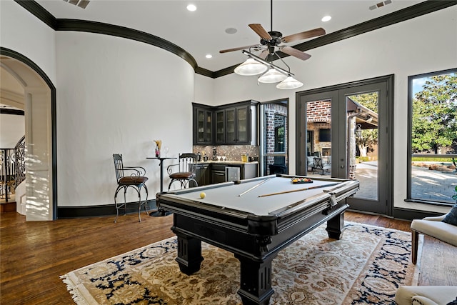 recreation room featuring billiards, bar, a healthy amount of sunlight, and dark hardwood / wood-style flooring