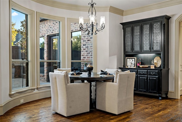 dining area with crown molding, a chandelier, and dark wood finished floors
