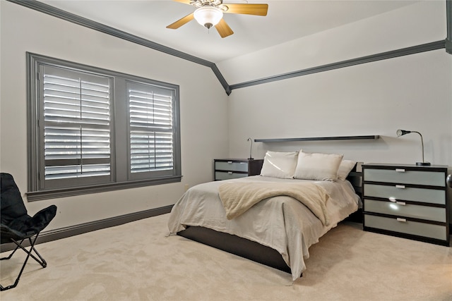 bedroom featuring ceiling fan, ornamental molding, vaulted ceiling, and light colored carpet