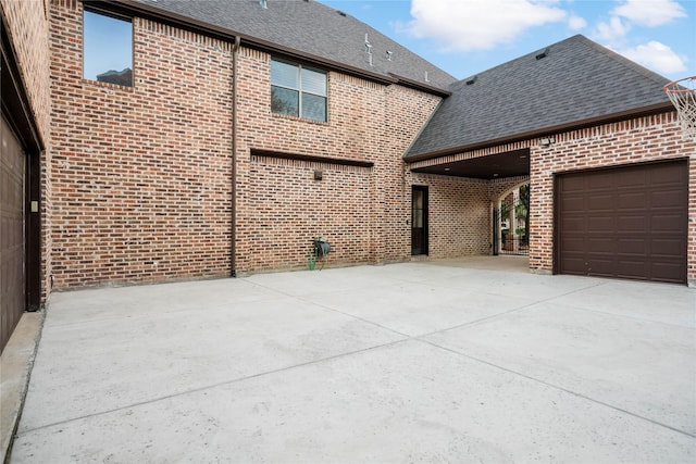 view of patio / terrace with an attached garage and concrete driveway