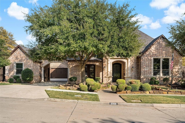 view of front of property with concrete driveway and brick siding