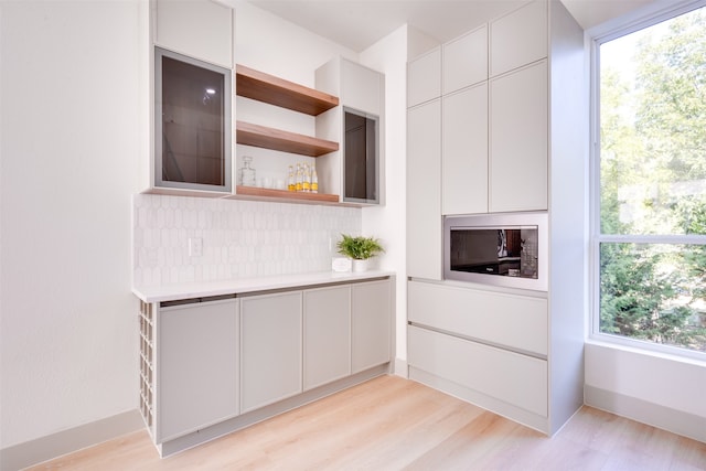 kitchen featuring plenty of natural light and light hardwood / wood-style floors