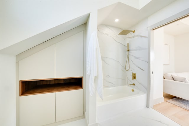 bathroom with hardwood / wood-style floors and tiled shower / bath combo