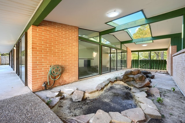 sunroom / solarium featuring lofted ceiling