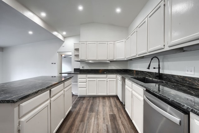 kitchen featuring dark hardwood / wood-style flooring, stainless steel dishwasher, dark stone counters, sink, and white cabinetry