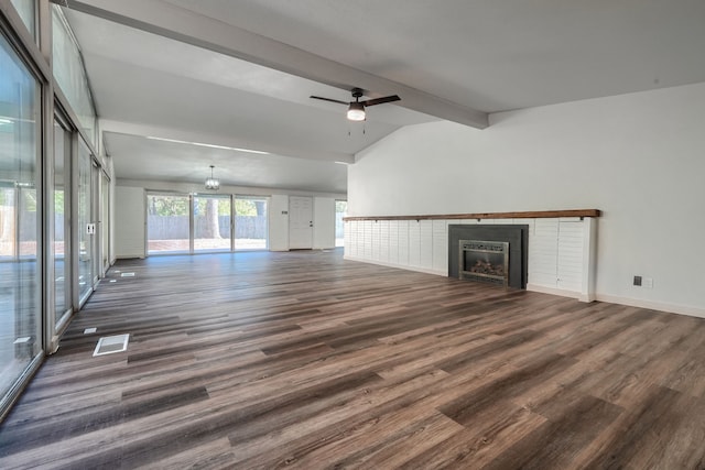 unfurnished living room with ceiling fan with notable chandelier, lofted ceiling with beams, and dark hardwood / wood-style floors