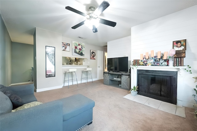 carpeted living room featuring indoor bar and ceiling fan