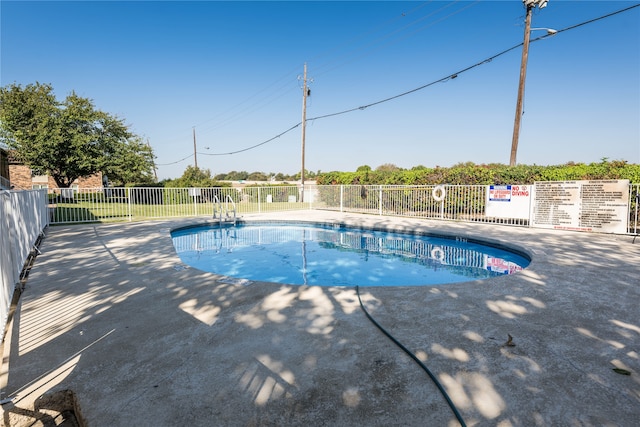 view of swimming pool with a patio area