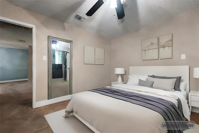 bedroom featuring a textured ceiling, carpet floors, and ceiling fan