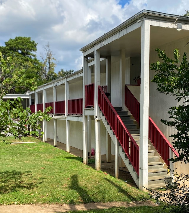 entrance to property featuring a lawn