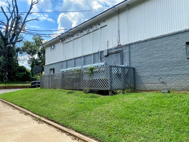 view of side of property featuring a deck and a lawn