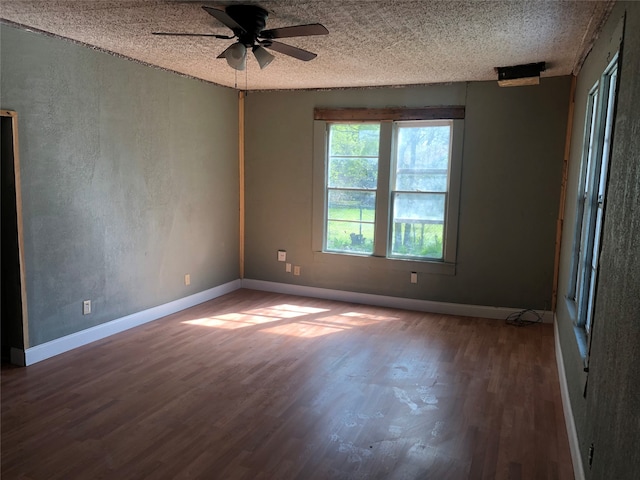 spare room with ceiling fan and dark hardwood / wood-style flooring