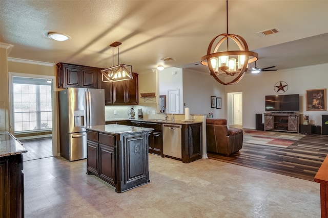 kitchen featuring dark brown cabinets, stainless steel appliances, hanging light fixtures, and light wood-type flooring