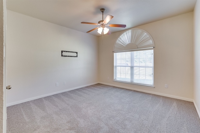 unfurnished room featuring light colored carpet and ceiling fan