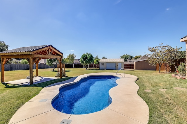 view of pool with a patio area, a gazebo, an outbuilding, and a lawn