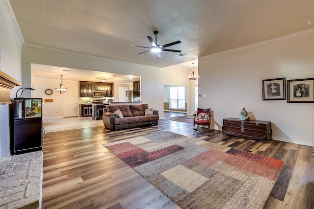 living room featuring ornamental molding, a textured ceiling, hardwood / wood-style flooring, and ceiling fan