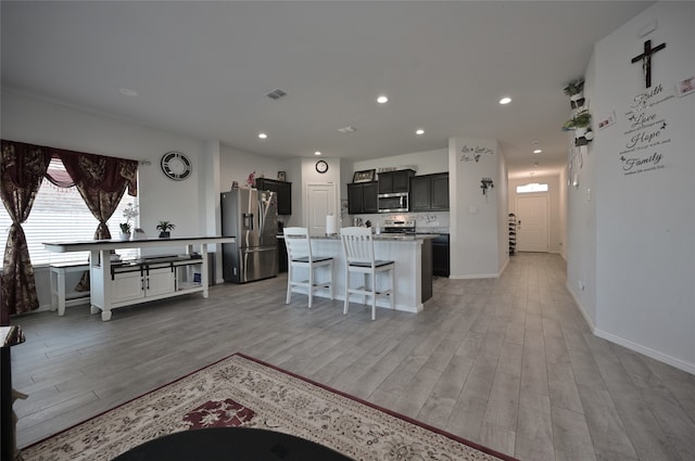 living room with light hardwood / wood-style flooring and a barn door