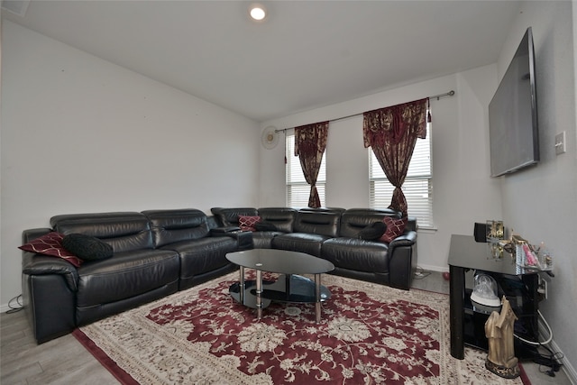 living room with vaulted ceiling and light hardwood / wood-style flooring