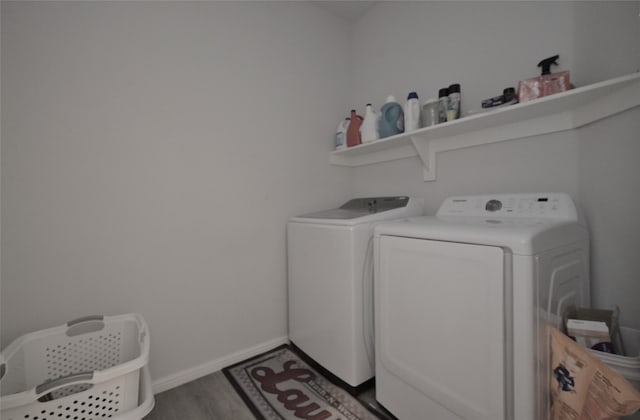 laundry area with washer and dryer and dark hardwood / wood-style floors