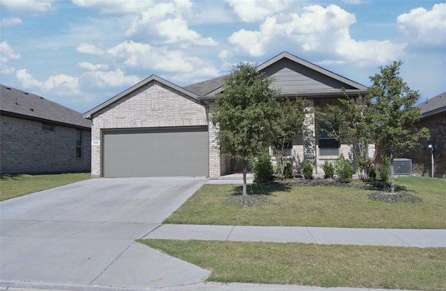 view of front of property featuring a front yard and a garage