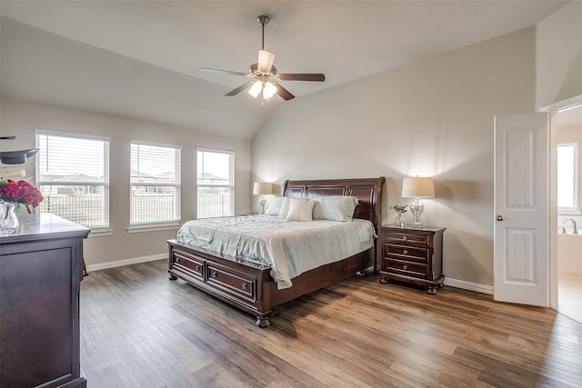 bedroom featuring ceiling fan, hardwood / wood-style flooring, and lofted ceiling