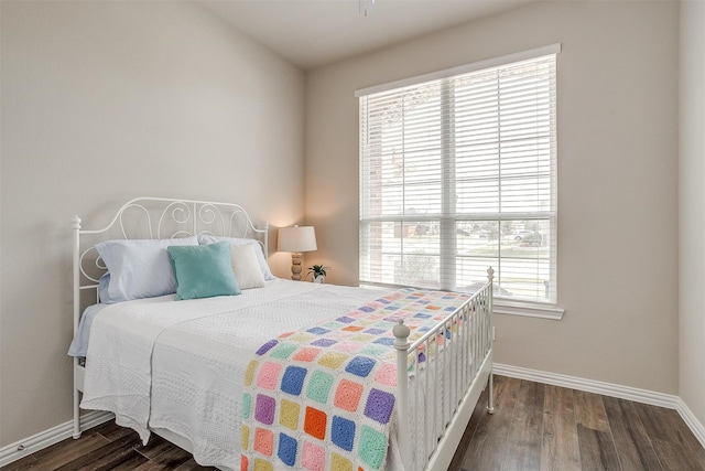 bedroom with dark wood-type flooring