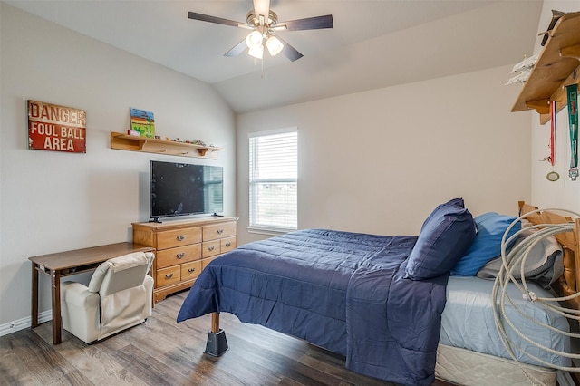 bedroom with ceiling fan, vaulted ceiling, and dark hardwood / wood-style floors