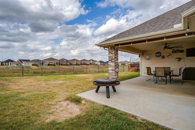 view of yard featuring an outdoor fire pit, a patio area, and ceiling fan