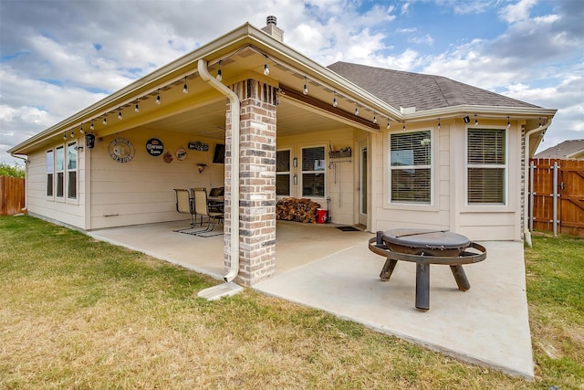 back of house with a patio area and a yard