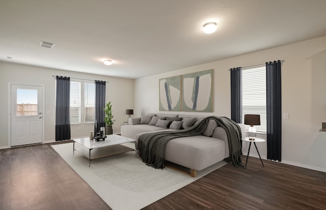 living room with dark hardwood / wood-style flooring