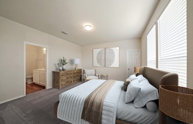 carpeted bedroom featuring connected bathroom