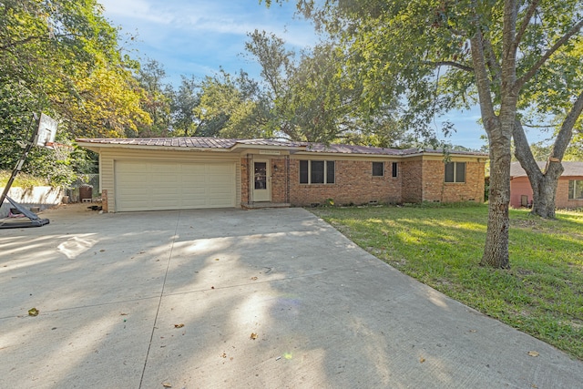 single story home featuring a front yard and a garage