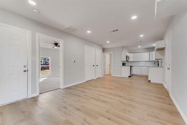 unfurnished living room with light hardwood / wood-style flooring and ceiling fan