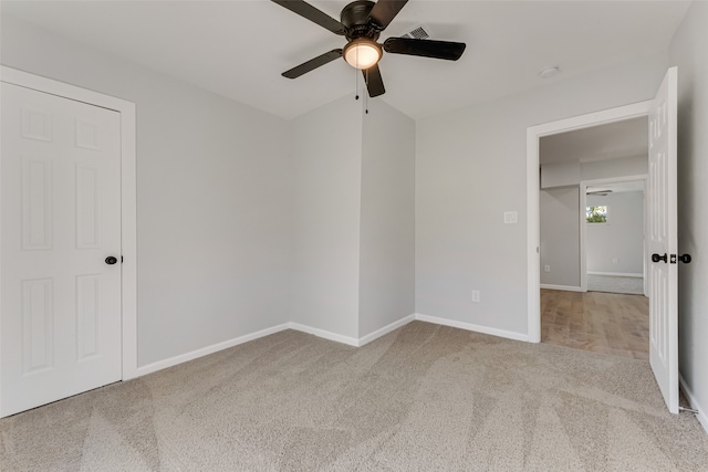 unfurnished bedroom with light carpet and ceiling fan