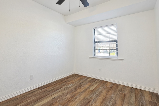 empty room featuring ceiling fan and dark wood-type flooring