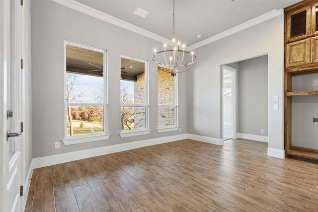 unfurnished dining area with a chandelier, crown molding, and wood-type flooring