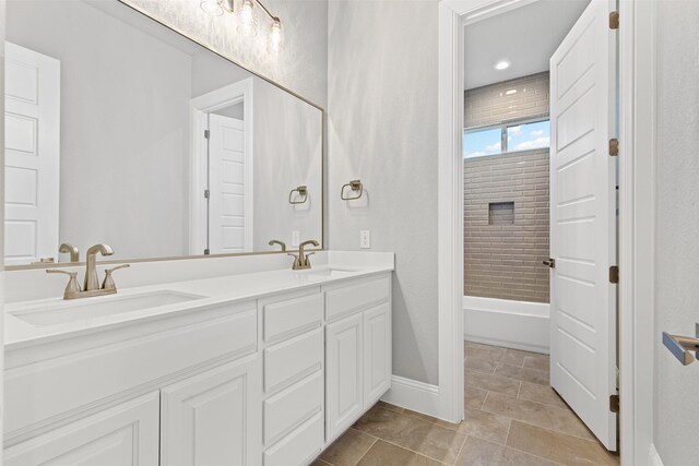 bathroom with vanity and tiled shower / bath