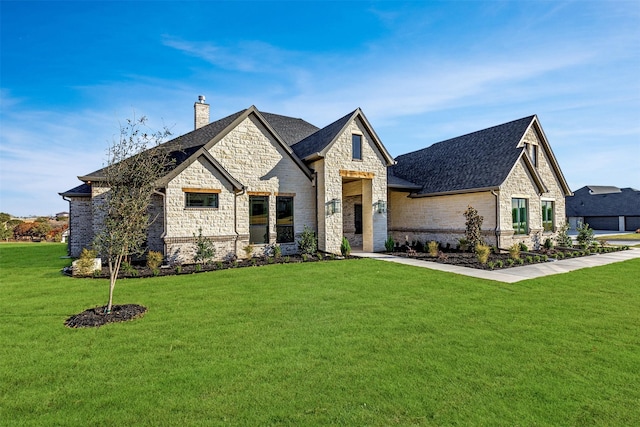 french provincial home with a front yard