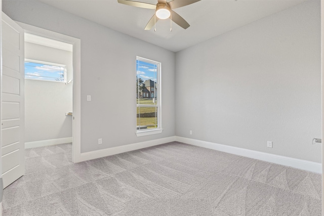 carpeted empty room featuring ceiling fan