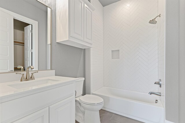 full bathroom with tile patterned flooring, toilet, vanity, and tiled shower / bath