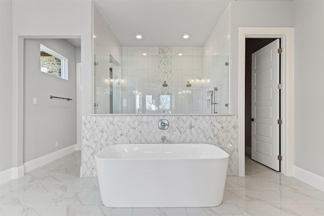 bathroom with shower with separate bathtub and tile walls