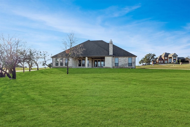 back of house featuring a yard