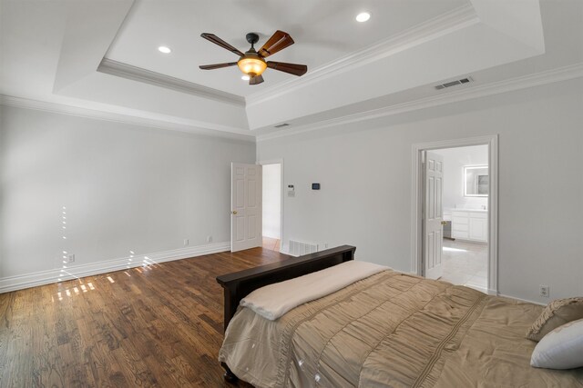 bedroom featuring crown molding, a tray ceiling, and ceiling fan