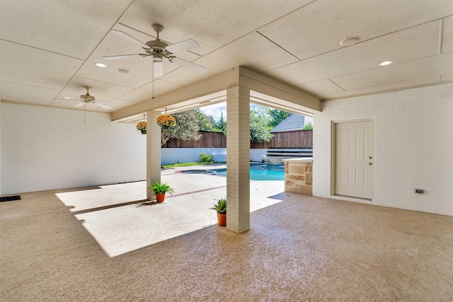 view of patio with ceiling fan and a fenced in pool