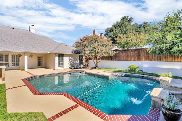 view of swimming pool with a patio area, pool water feature, and an in ground hot tub